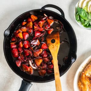 sauteed onions and strawberries in a pan.