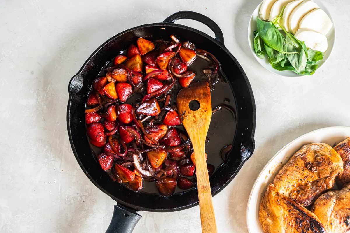 sauteed onions and strawberries in a pan.