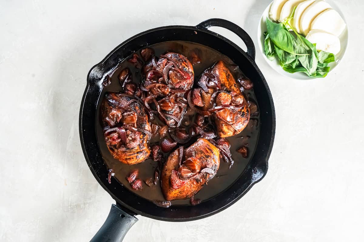 cooked down strawberry balsamic chicken in a pan.