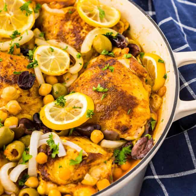 partial view of moroccan chicken thighs in a pot.