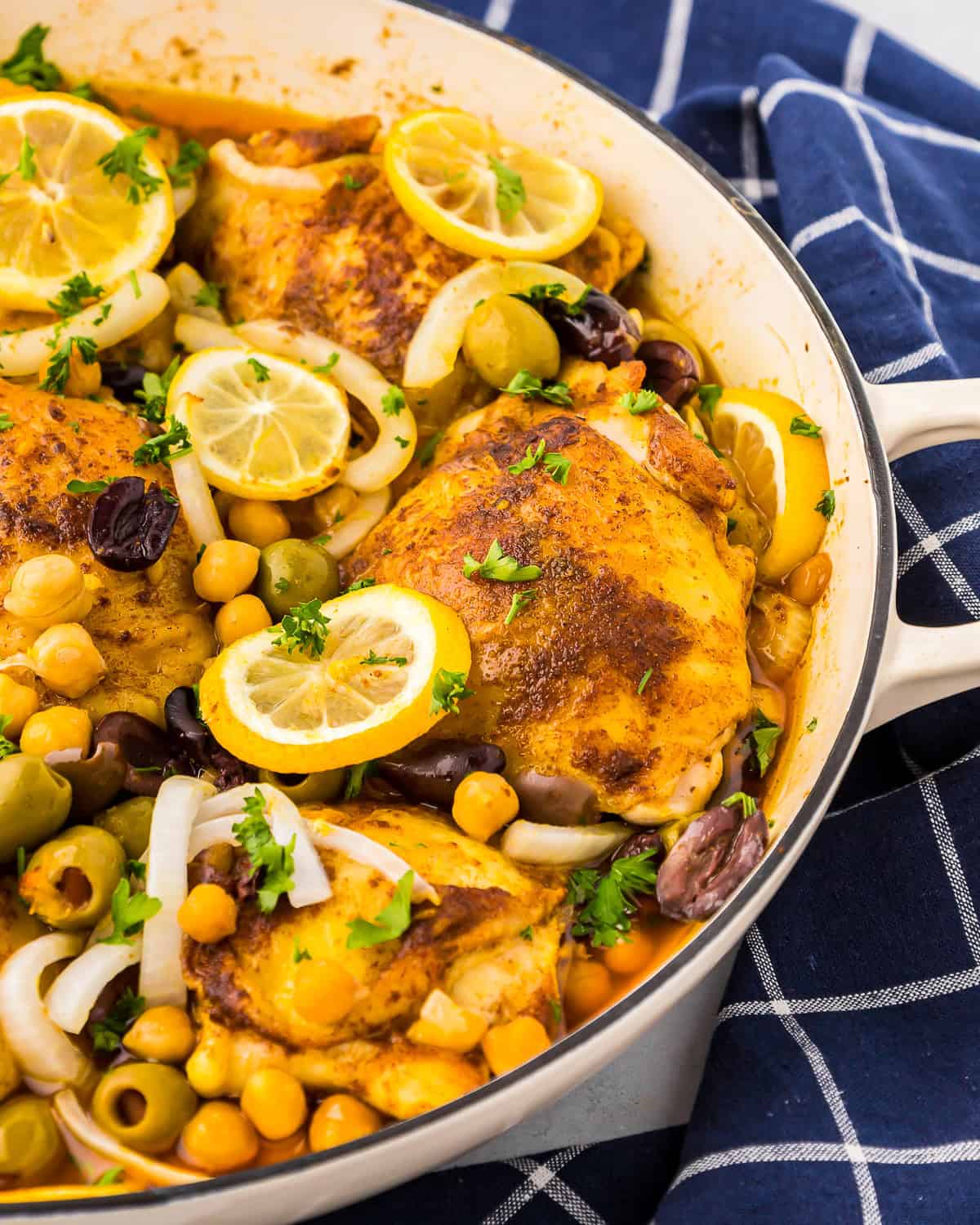 partial view of moroccan chicken thighs in a pot.