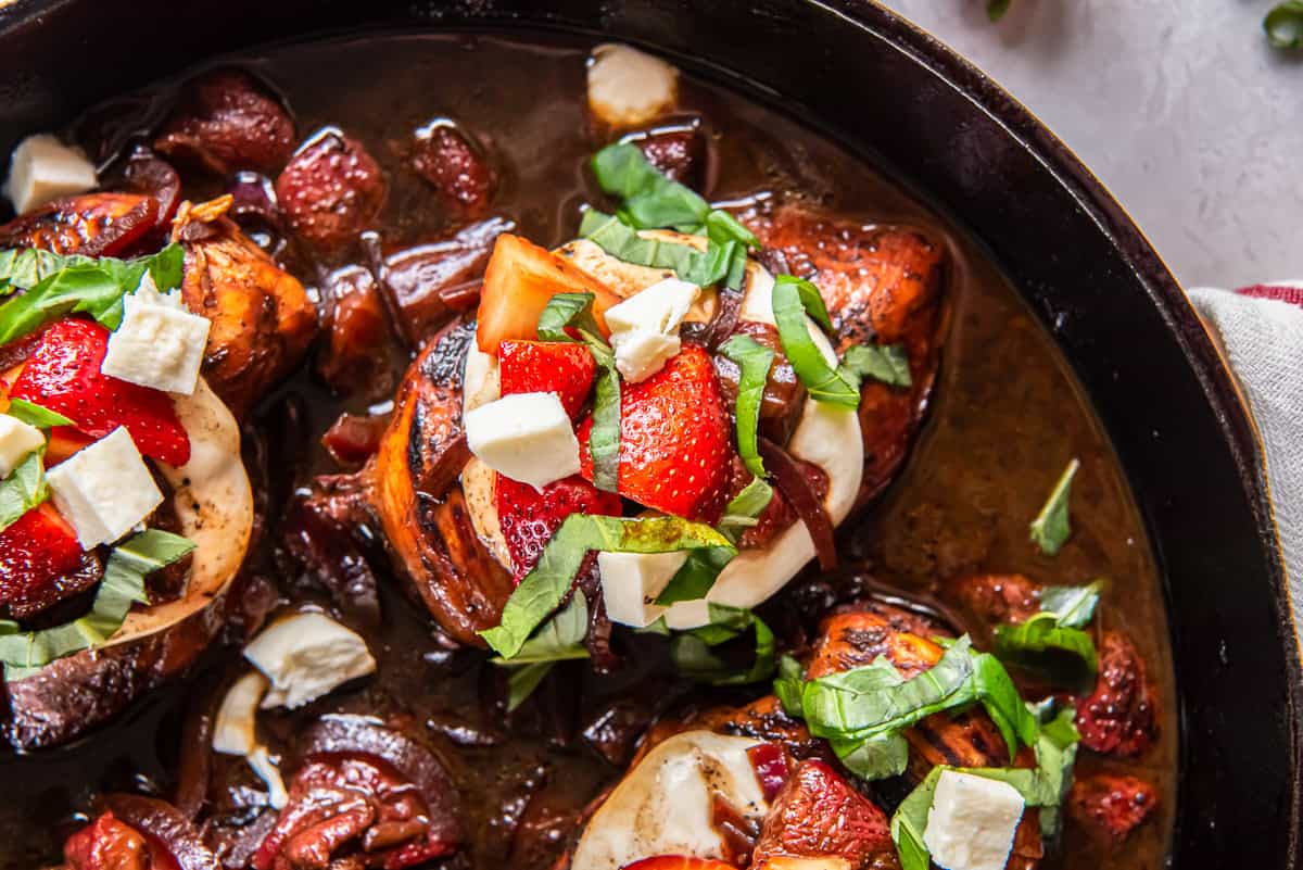 close up view of strawberry balsamic chicken in a pan.