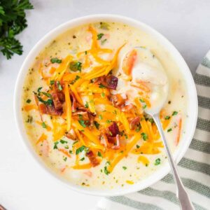 overhead image of chicken chowder garnished with cheese and bacon