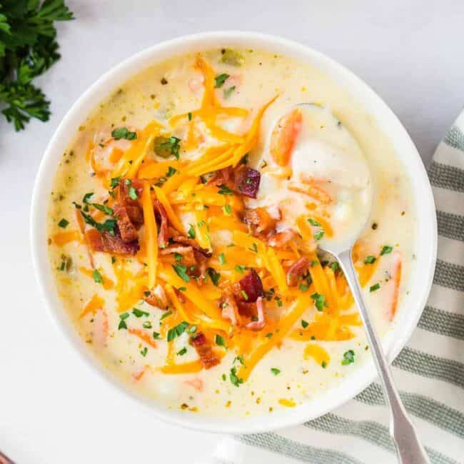 overhead image of chicken chowder garnished with cheese and bacon