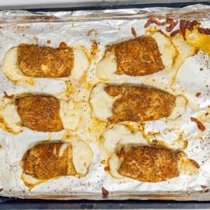 baked chicken roll ups on a baking sheet.