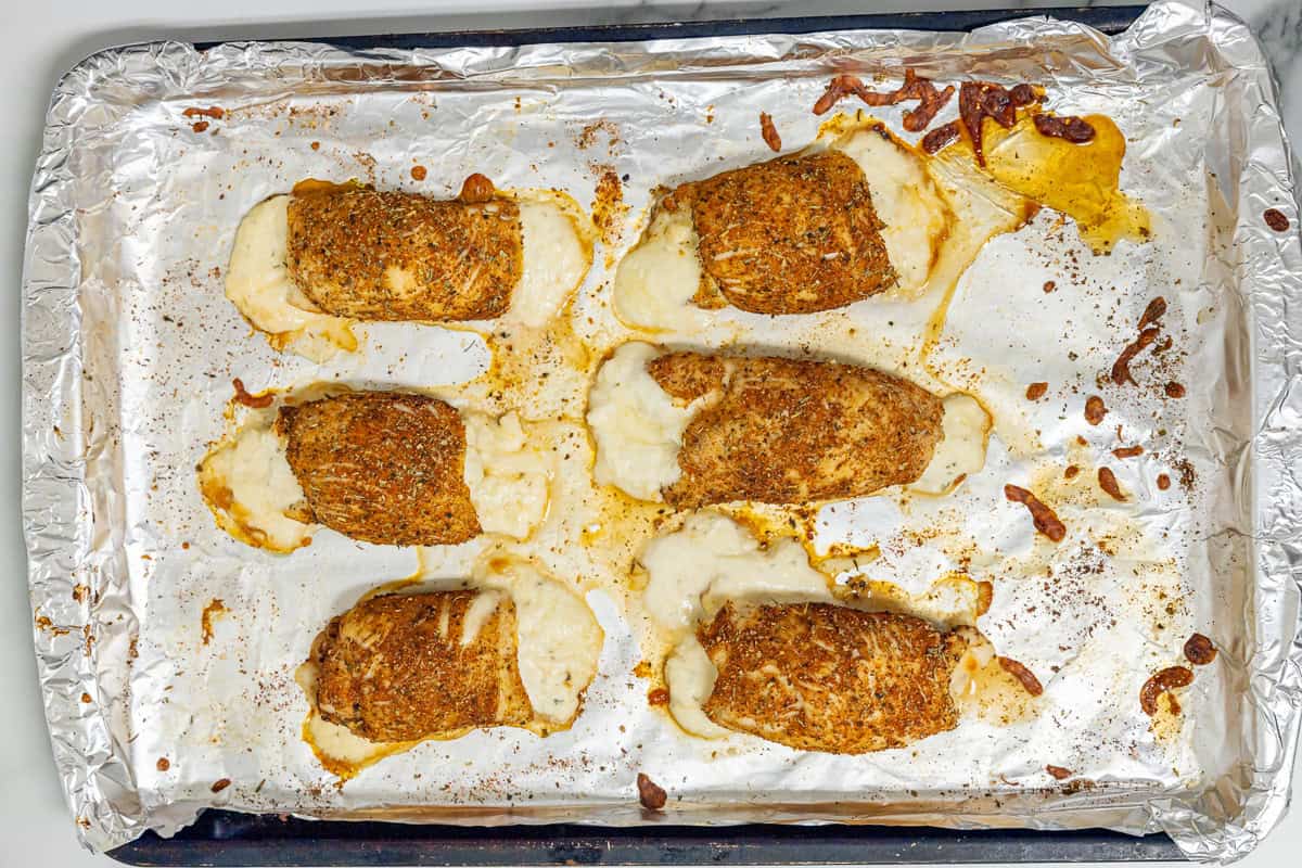 baked chicken roll ups on a baking sheet.