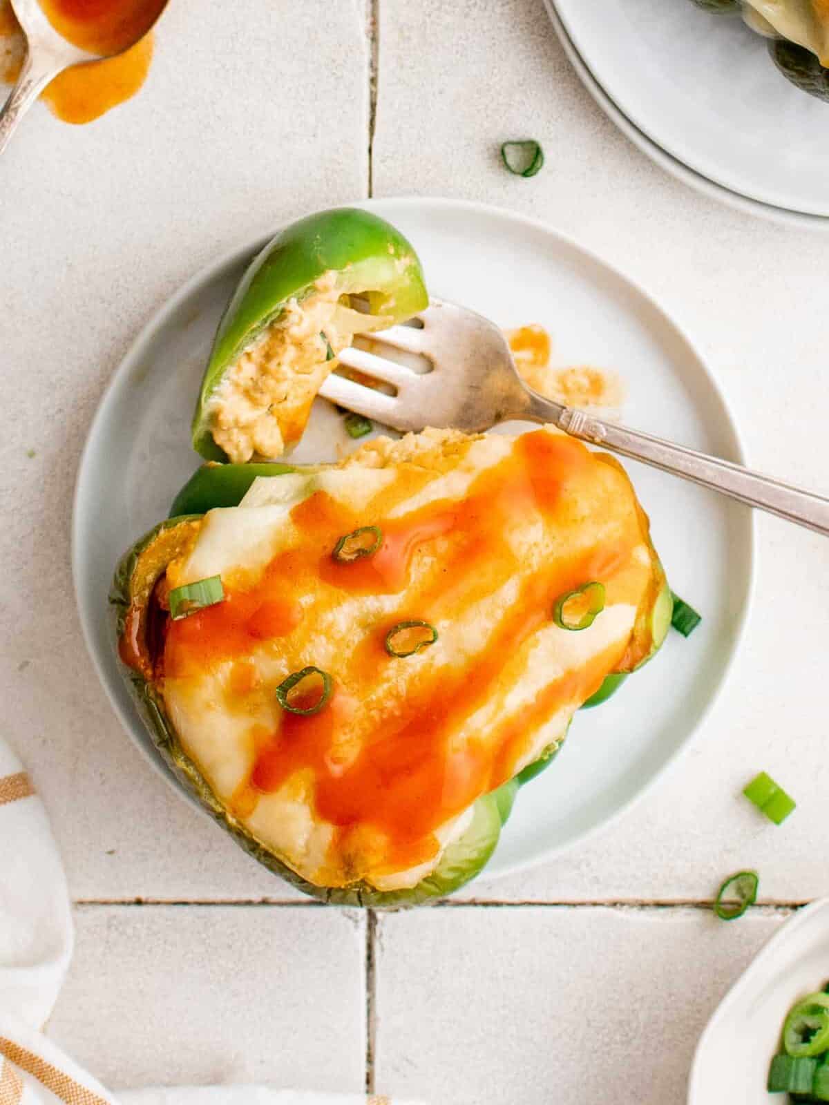 buffalo chicken stuffed pepper on a plate with a fork