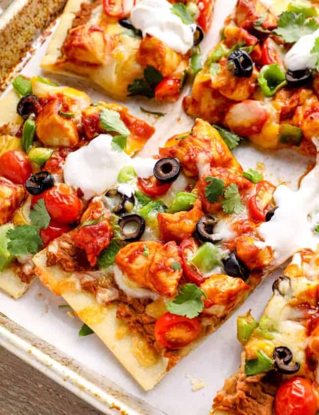 slices of chicken taco pizza on a baking sheet