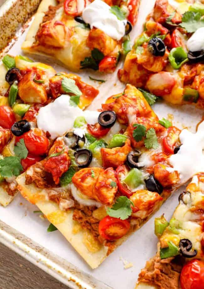 slices of chicken taco pizza on a baking sheet