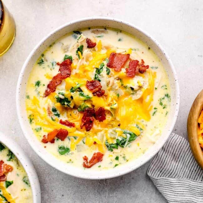 crack chicken soup in a white bowl