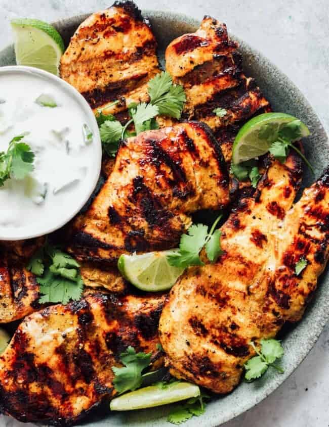 grilled tandoori chicken breasts on a gray plate