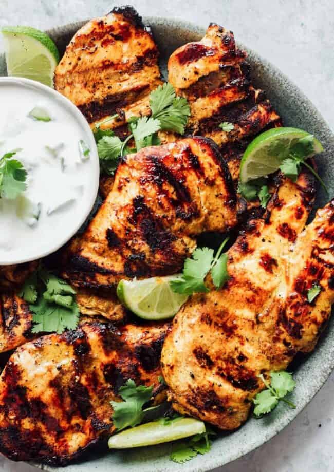 grilled tandoori chicken breasts on a gray plate