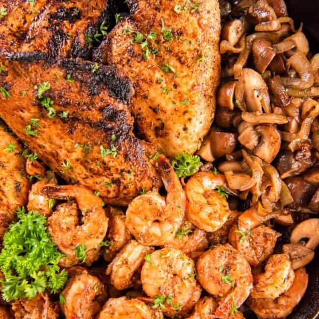 overhead view of applebees bourbon street chicken and shrimp in a skillet.