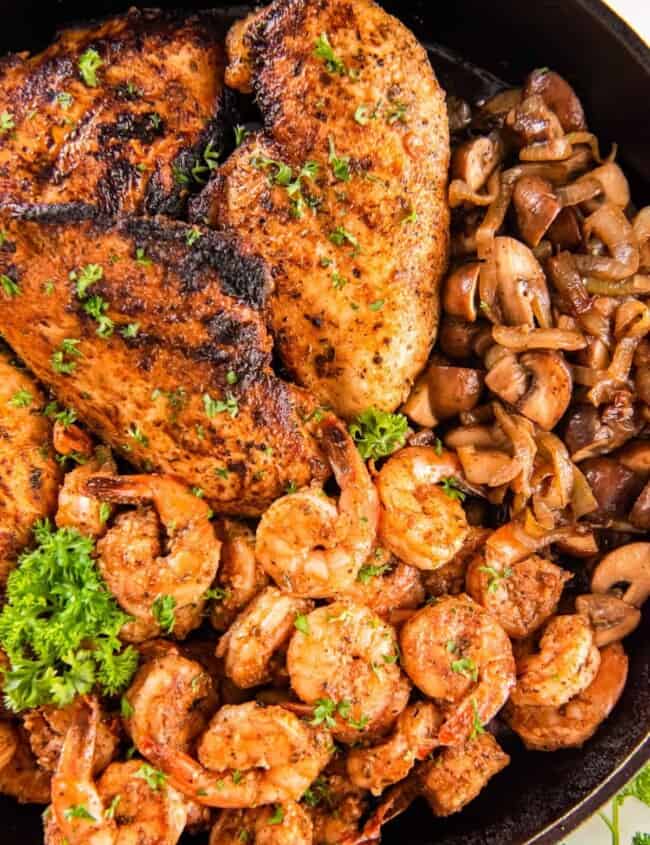 overhead view of applebees bourbon street chicken and shrimp in a skillet.