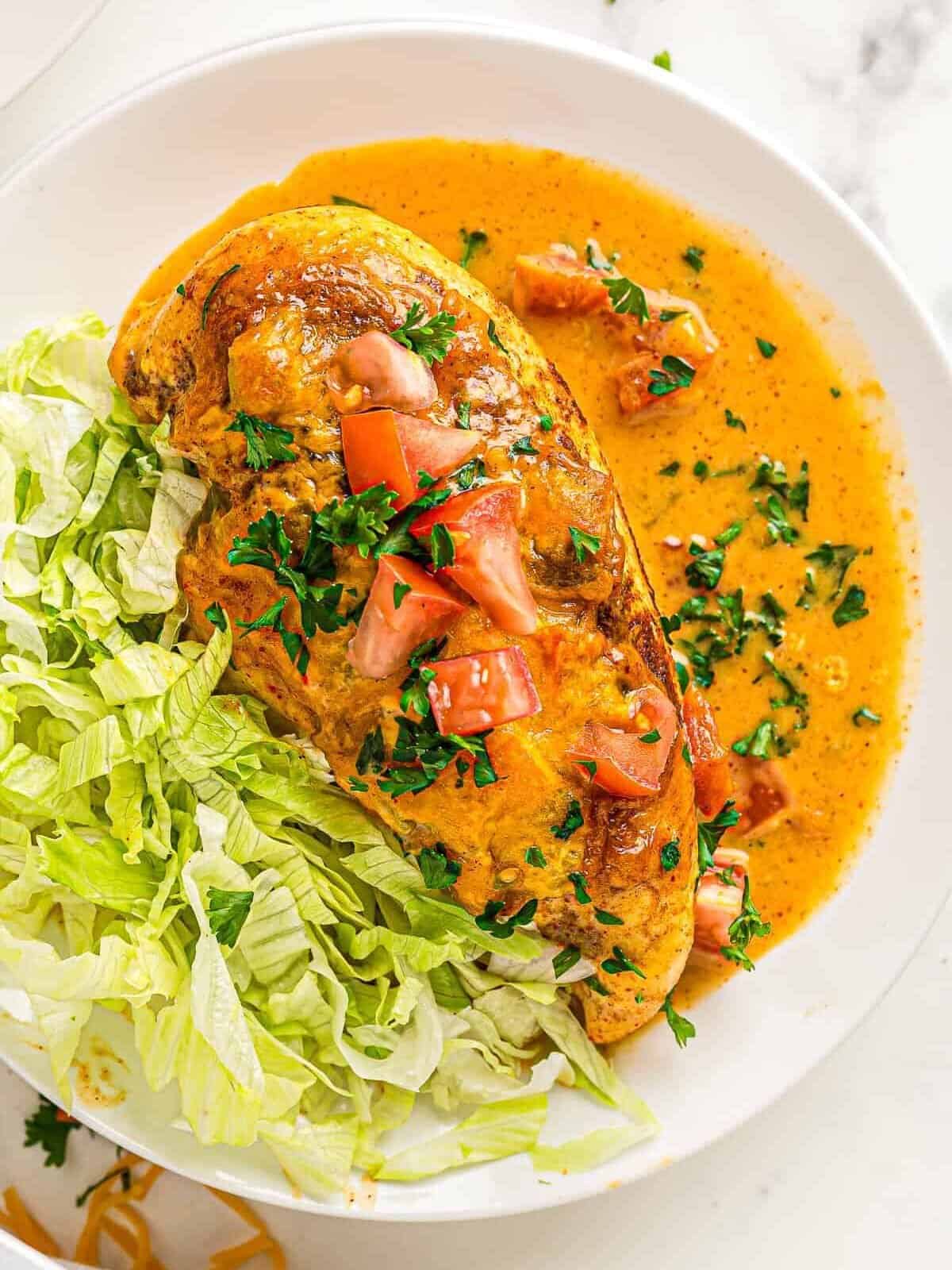 chicken on queso with lettuce and tomato
