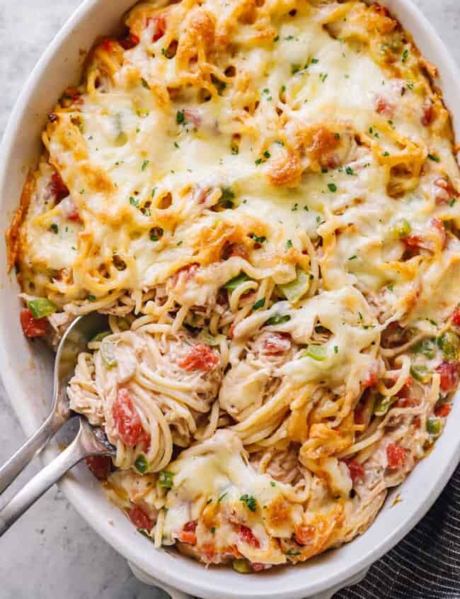 creamy baked chicken spaghetti in a large white casserole dish