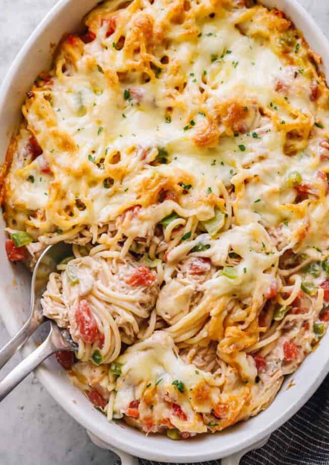 creamy baked chicken spaghetti in a large white casserole dish
