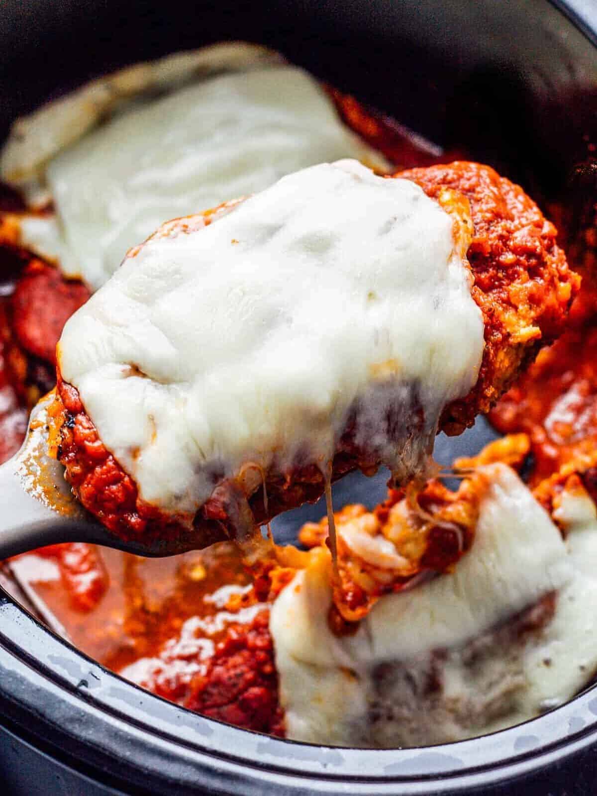 lifting up chicken parmesan in crockpot