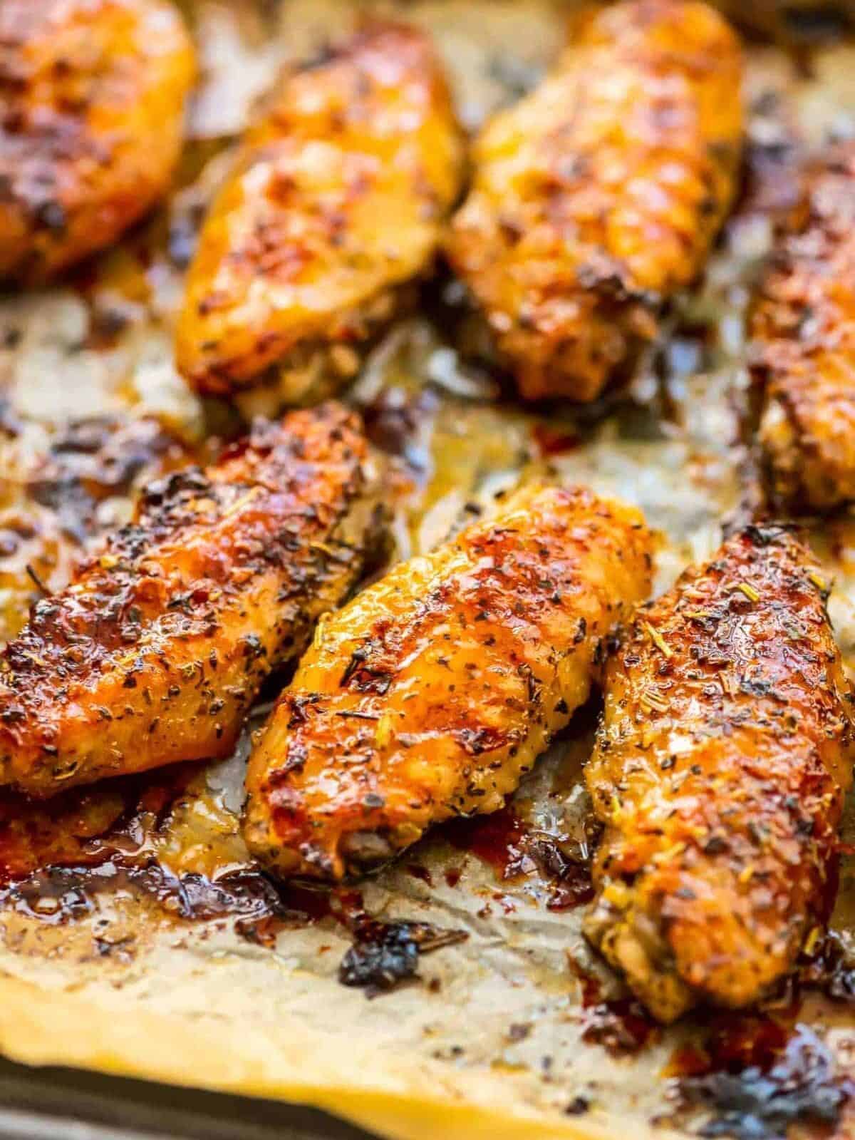 up close picture of baked chicken wings on sheet pan