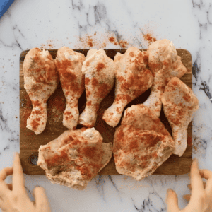 raw pieces of chicken coated in paprika.