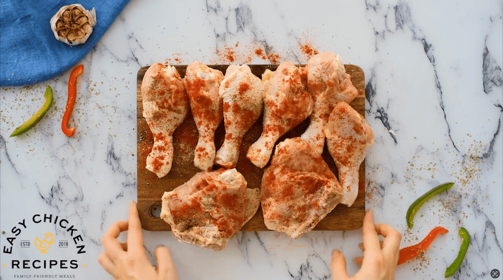 raw pieces of chicken coated in paprika.