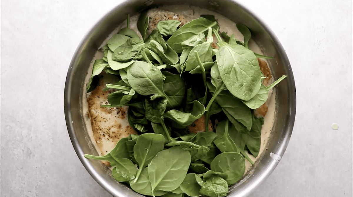 handful of fresh spinach on top of chicken.