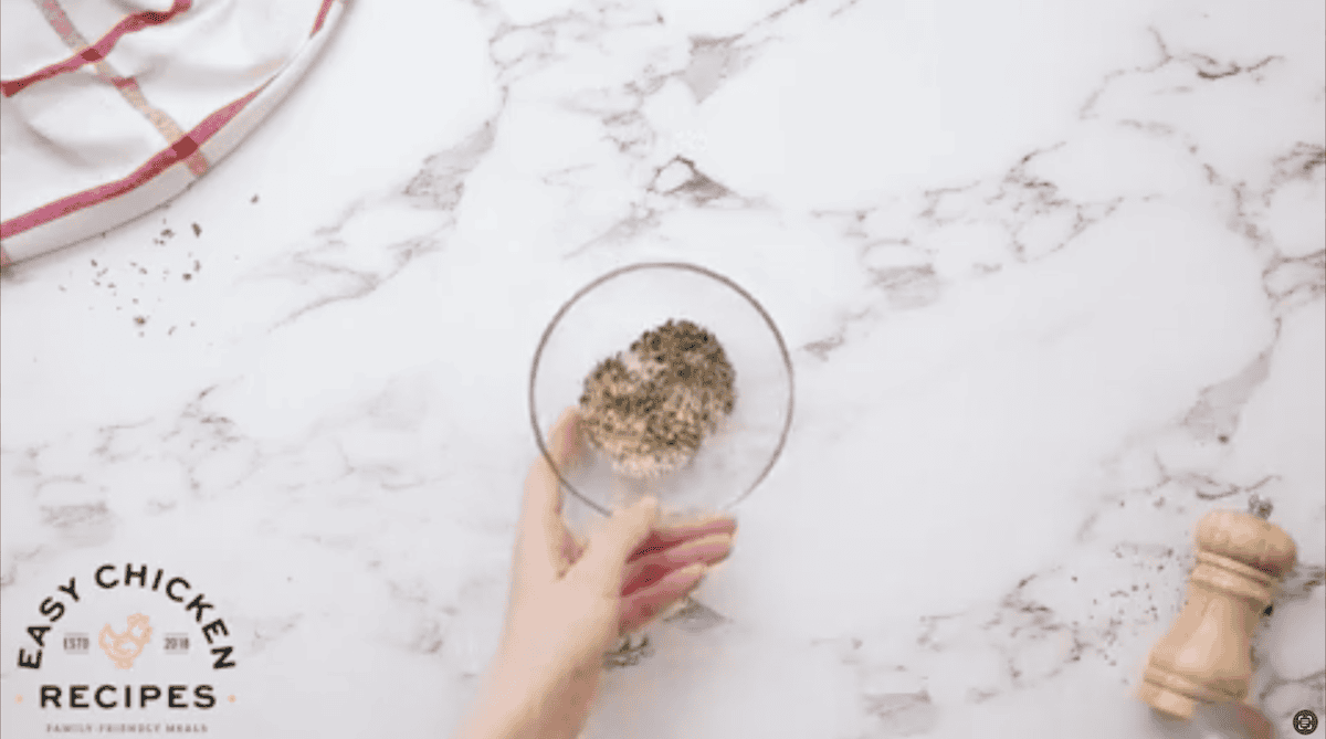 Herbs and spices combined in a small glass bowl.