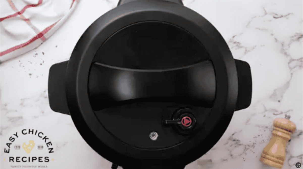 Overhead view of a pressure cooker with the lid on.