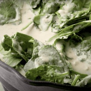 spinach cooking in a creamy sauce.