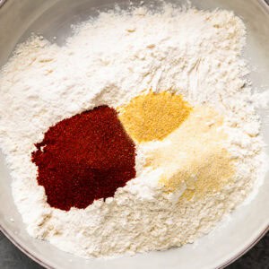 A mix of flour and spices in a shallow dish.