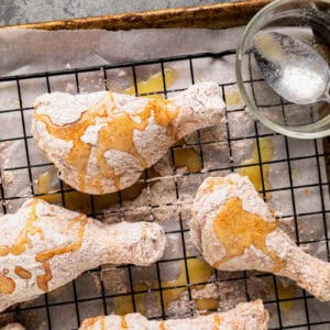 Flour-coated drumsticks drizzled with melted butter.
