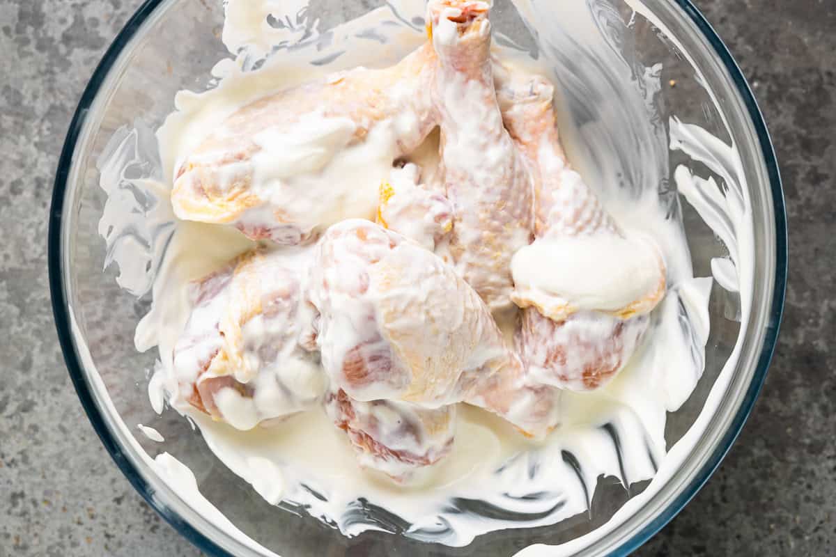 Chicken drumsticks coated in Greek yogurt.
