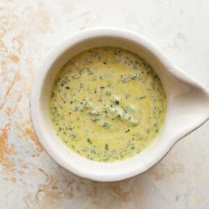 creamy dressing in a white bowl.