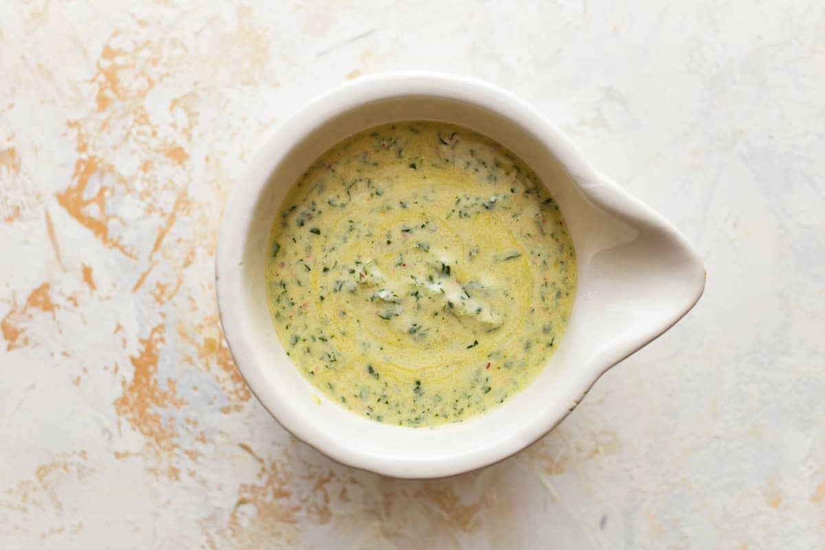 creamy dressing in a white bowl.