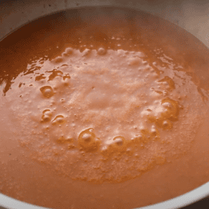 Red enchilada sauce in a pan.