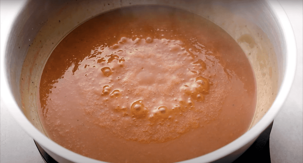 Red enchilada sauce in a pan.