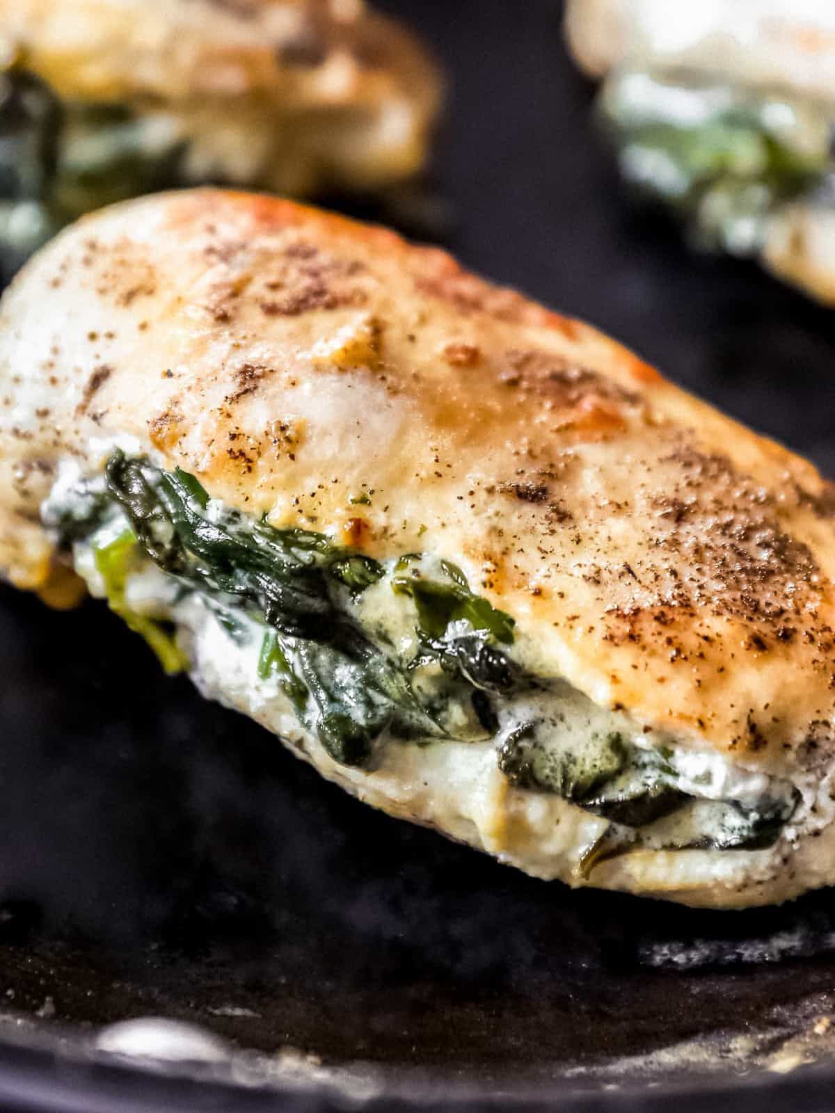 close up on chicken breast stuffed with spinach and cream cheese