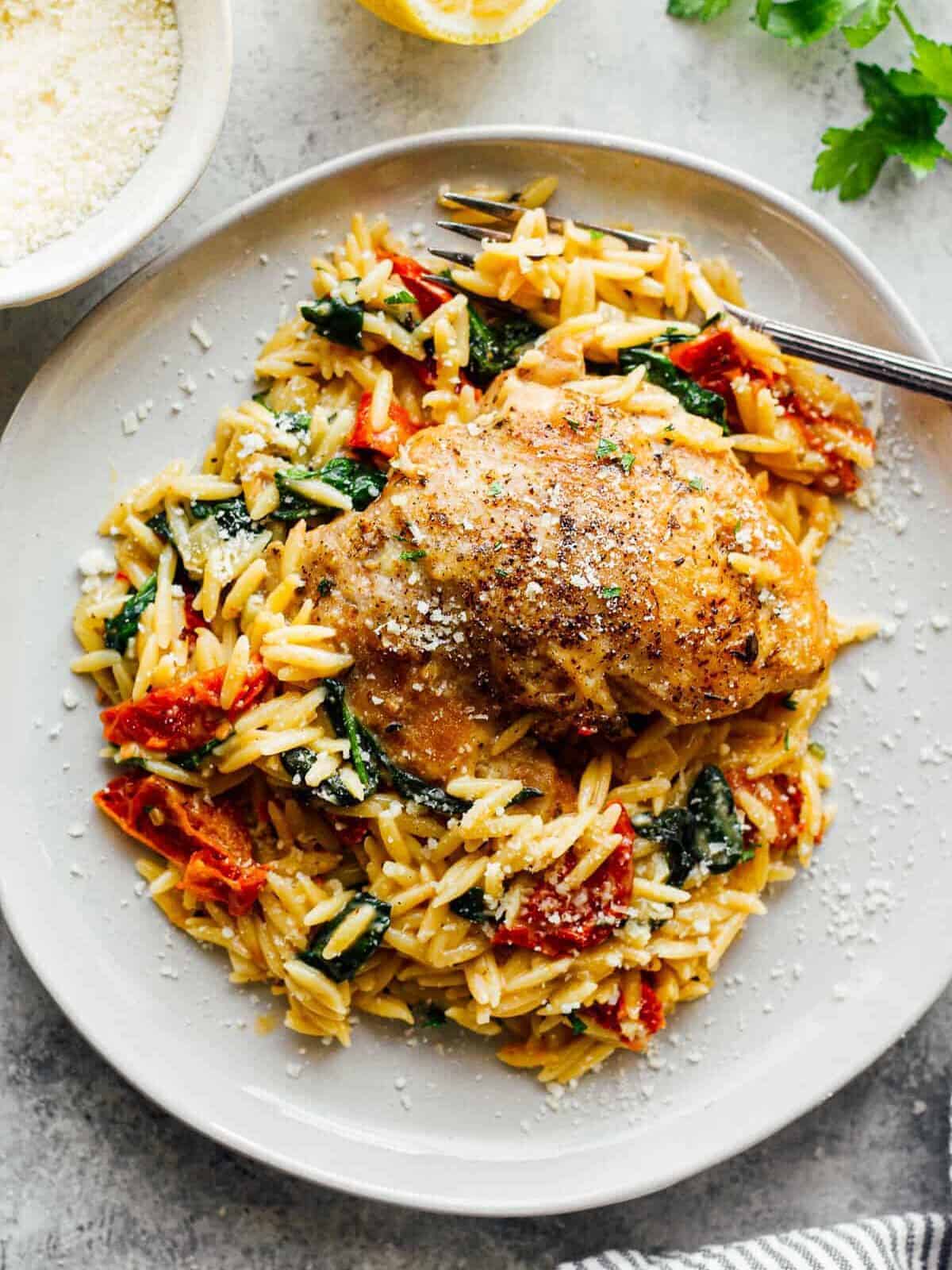 plate with tuscan chicken thigh and orzo