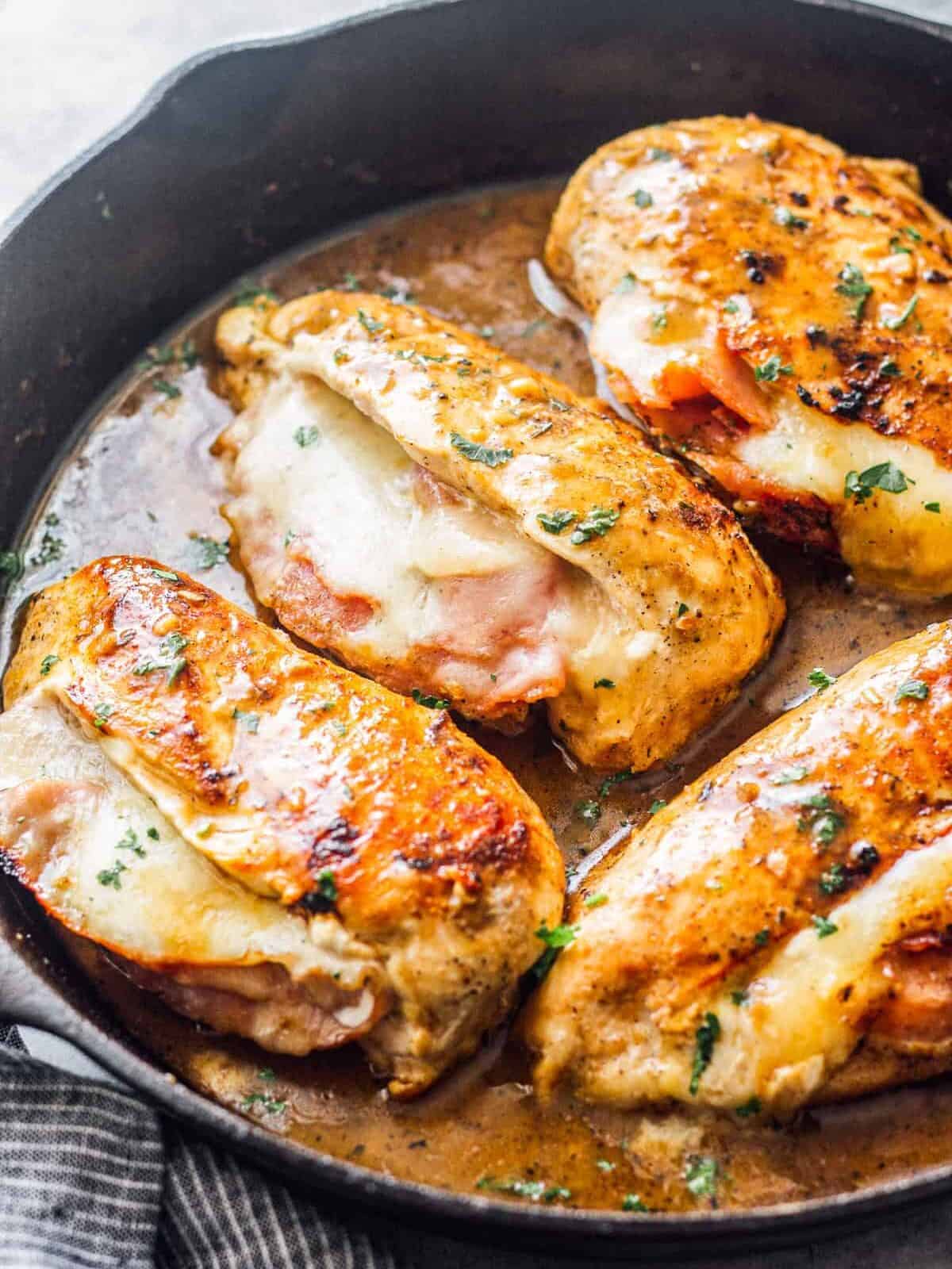ham and cheese stuffed chicken in skillet