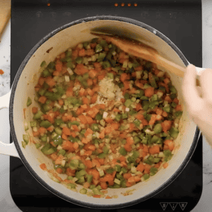 Cooking onion, celery, and bell pepper with minced garlic.