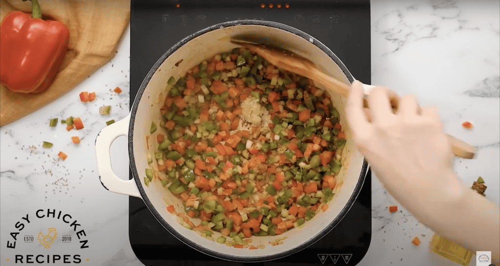 Cooking onion, celery, and bell pepper with minced garlic.