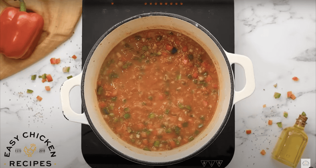 Jambalaya simmering in a large pot.