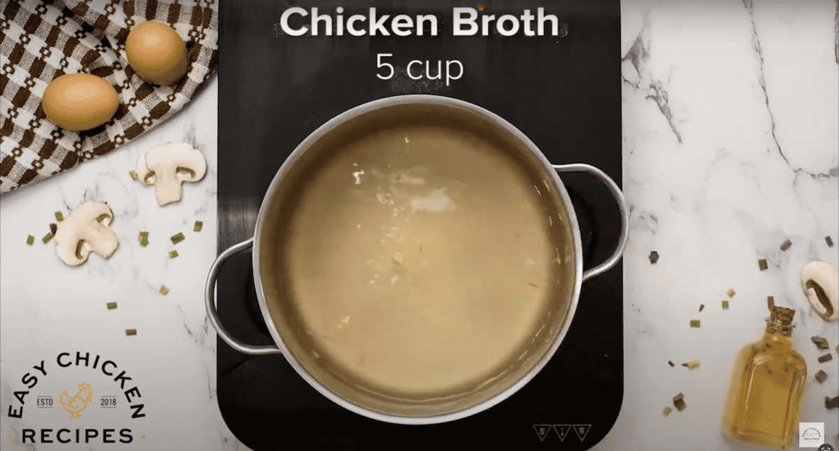 A large pot filled with chicken broth.