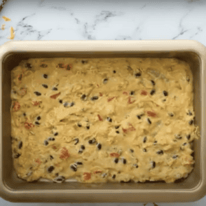 Casserole mixture spread in an even layer on the bottom of a baking dish.