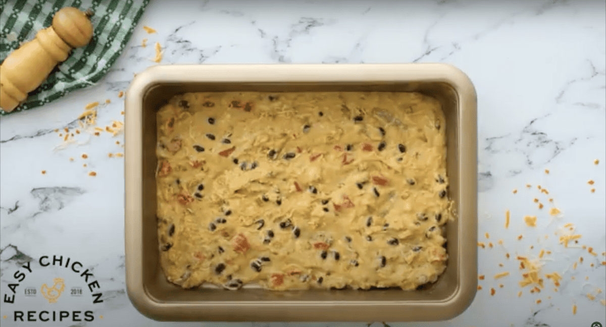 Casserole mixture spread in an even layer on the bottom of a baking dish.