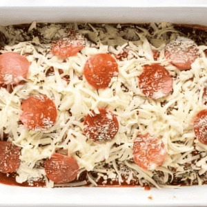 stuffed chicken breasts topped with cheese and pepperoni in a baking pan.