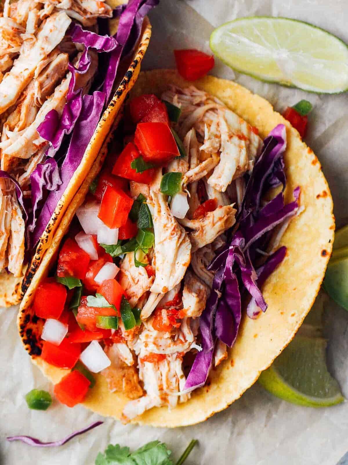 Close up on a taco filled with Instant pot pulled chicken meat.