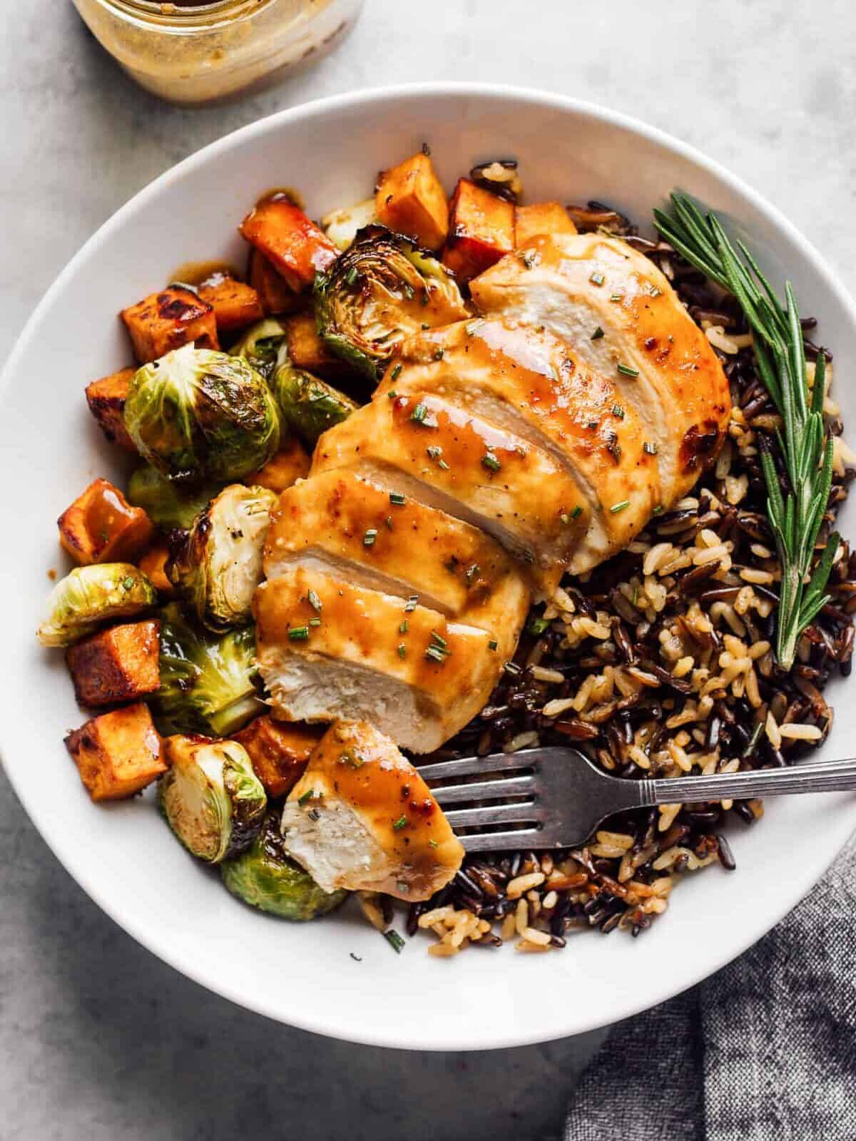 sliced maple dijon chicken with rice and vegetables