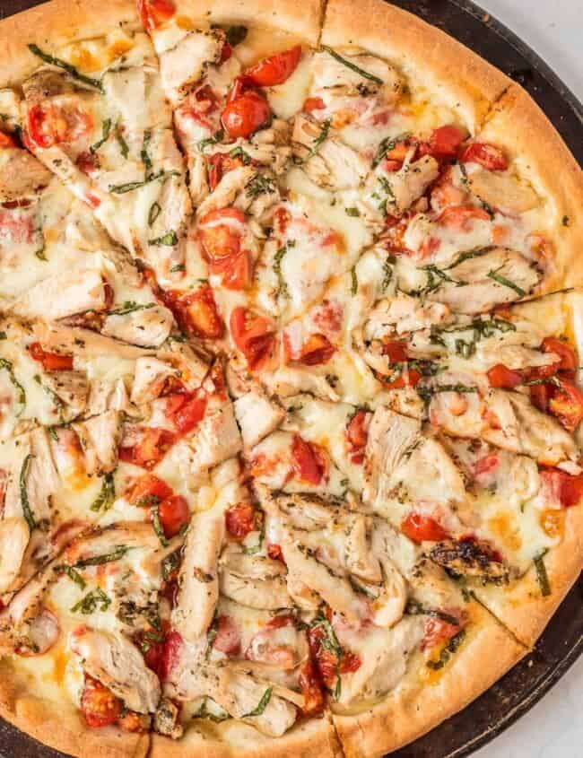 up close image of sliced chicken margherita pizza