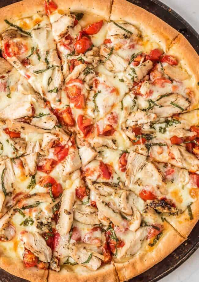 up close image of sliced chicken margherita pizza